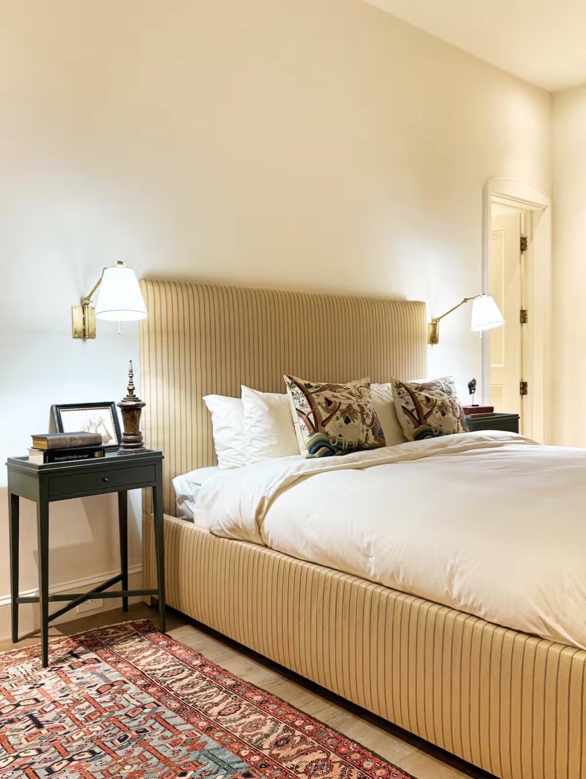 Bedroom with channel-tufted bed and Persian rug